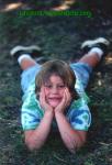 Danci, 8, lies on the grass